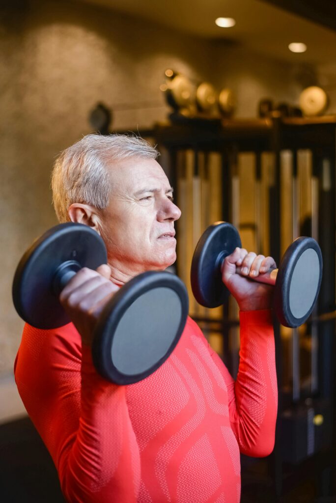 man in red lifting weights