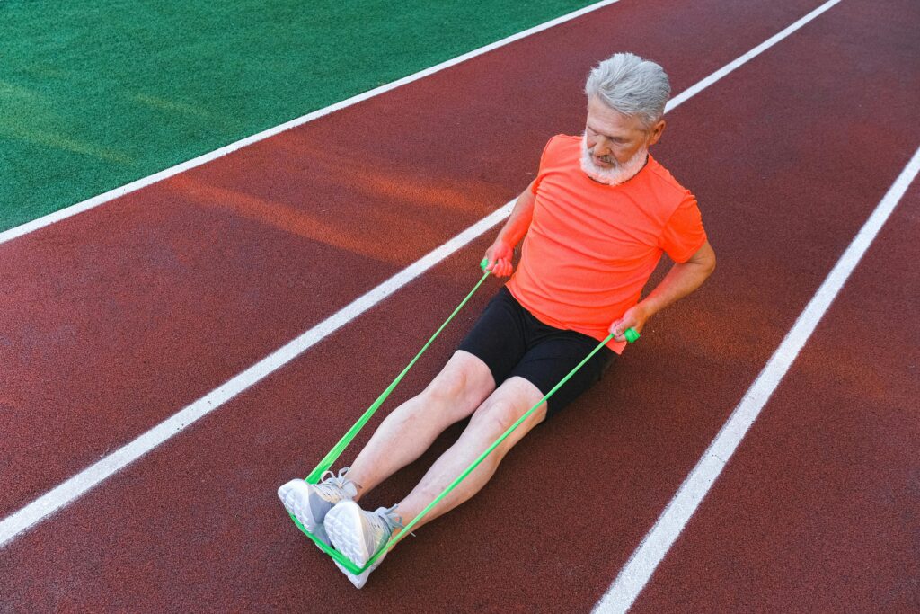 man works out on a track with a resistance band