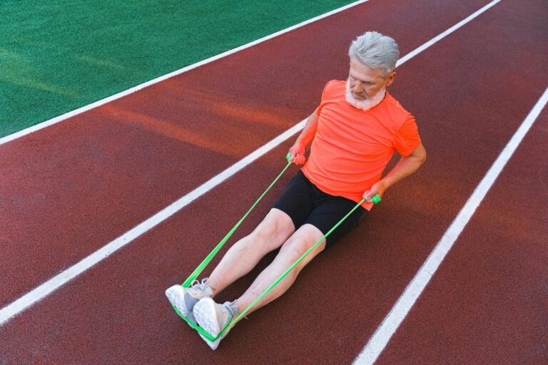 man works out on a track with a resistance band