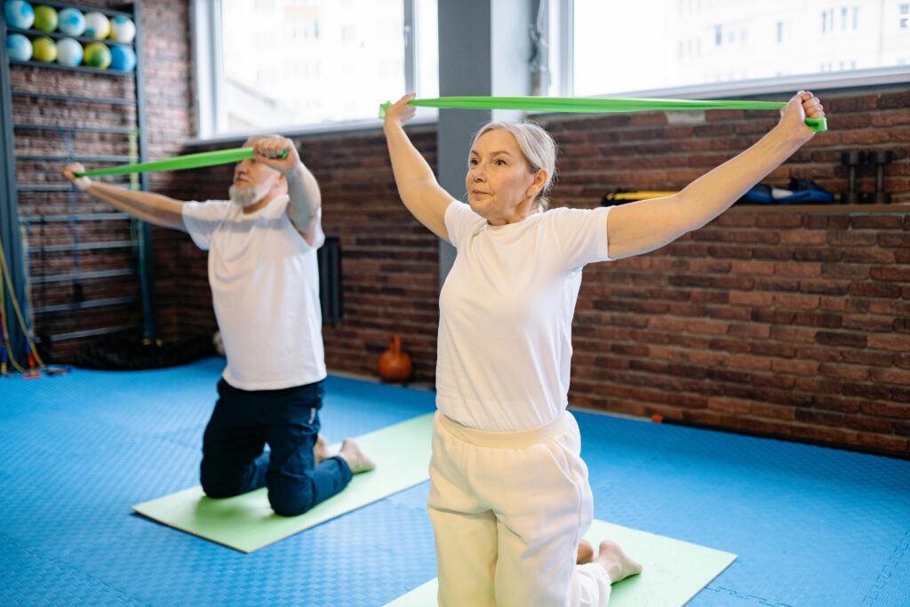 man and woman work out using resistance bands