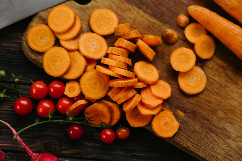 carrots and tomatoes on a cutting board