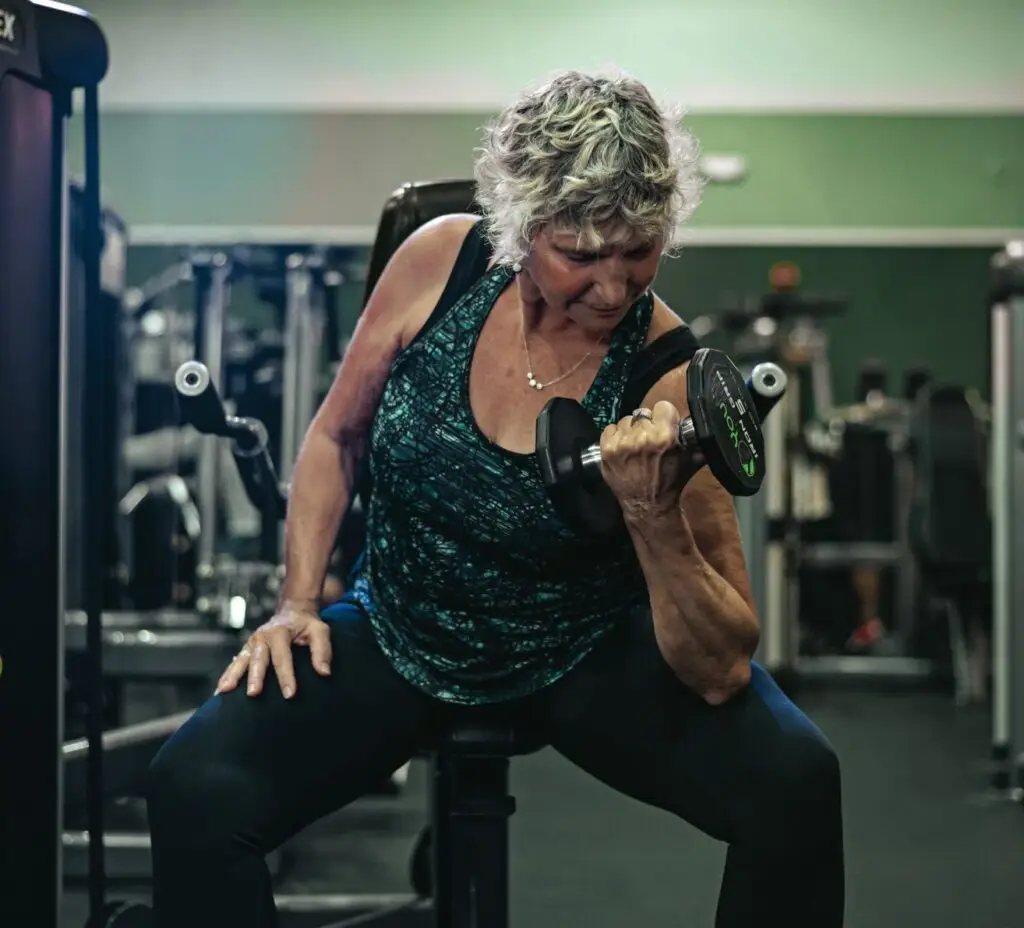 Woman curls a dumbbell